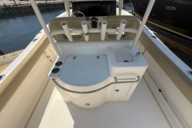 Slide: The Image of 2019 Key West Billistic 281 Center Console boat interior with rod holders and sink. - 38