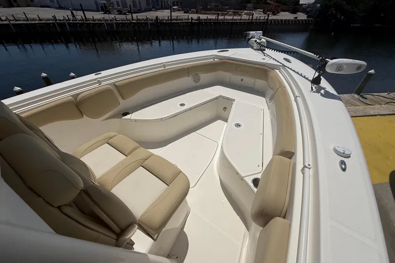 Slide: The Image of 2019 Key West Billistic 281 Center Console boat with beige seating and spacious deck. - 80