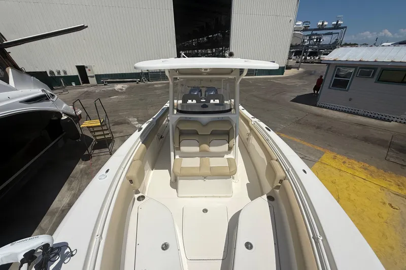 Slide: The Image of 2019 Key West Billistic 281 Center Console boat at a marina, showcasing spacious seating. - 85