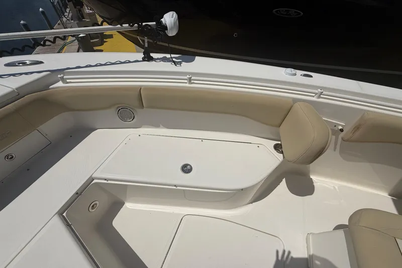 Slide: The Image of 2019 Key West Billistic 281 Center Console boat interior with beige seating and storage compartments. - 90