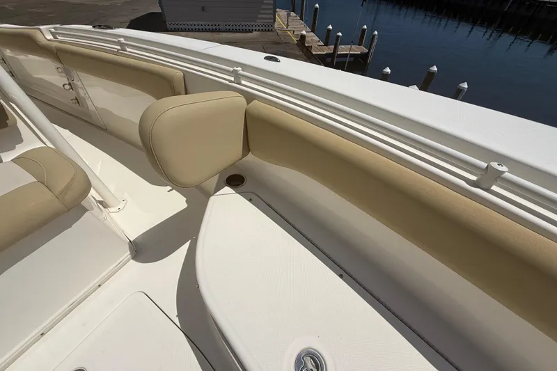 Slide: The Image of 2019 Key West Billistic 281 Center Console boat interior with beige seating and white deck. - 92