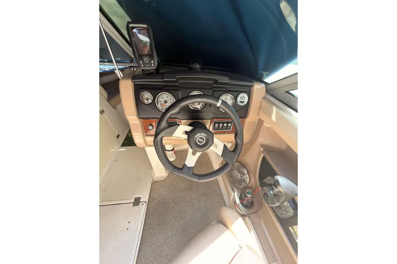 Slide: The Image of Interior view of 2012 Chaparral 216 SSi boat dashboard with steering wheel and gauges. - 16