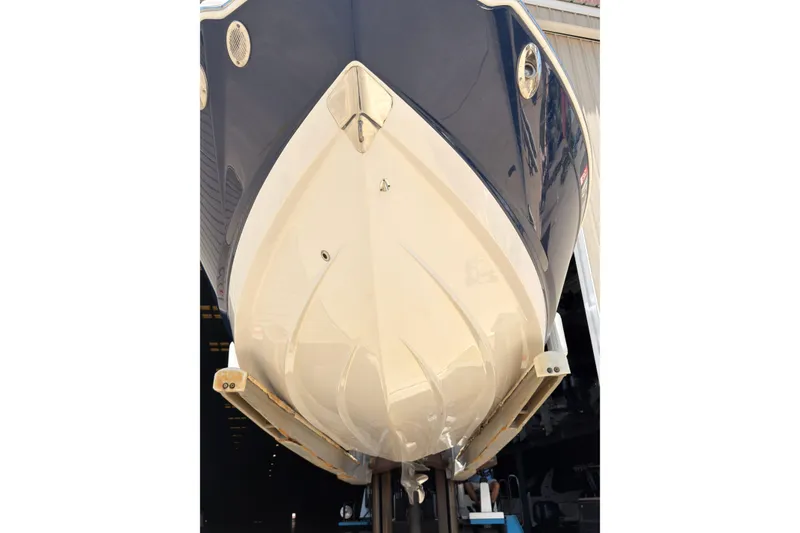 Slide: The Image of 2012 Chaparral 216 SSi boat hull, showcased in a storage facility. - 33