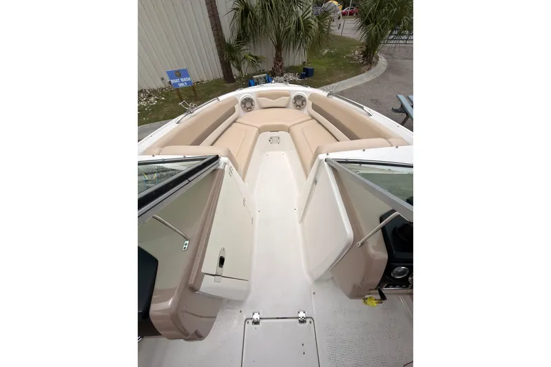 Slide: The Image of 2012 Chaparral 216 SSi boat interior with beige seating and open windshield. - 10