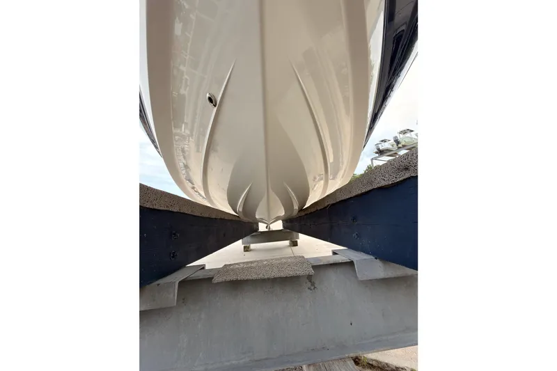 Slide: The Image of Underside view of a 2012 Chaparral 216 SSi boat on a support structure. - 34