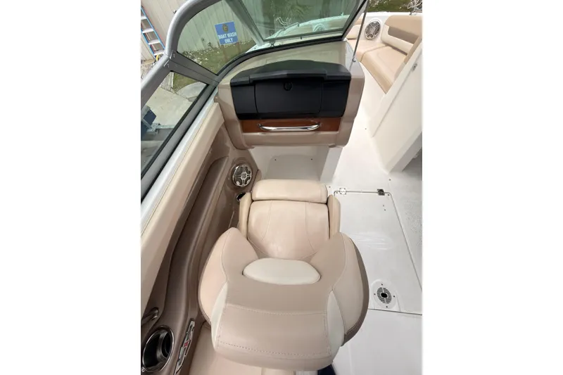 Slide: The Image of Interior of 2012 Chaparral 216 SSi boat with beige seating and dashboard. - 14