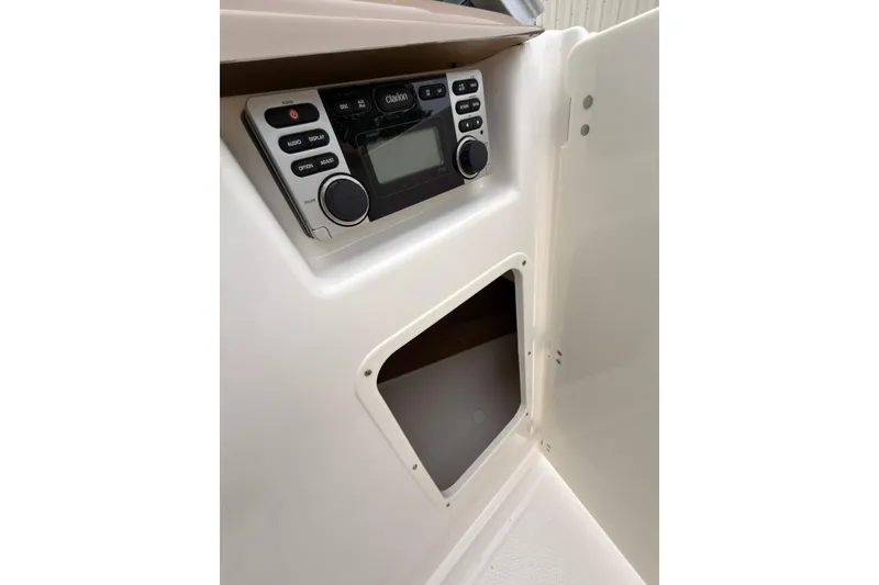 Slide: The Image of 2012 Chaparral 216 SSi boat interior with Clarion audio system and storage compartment. - 20