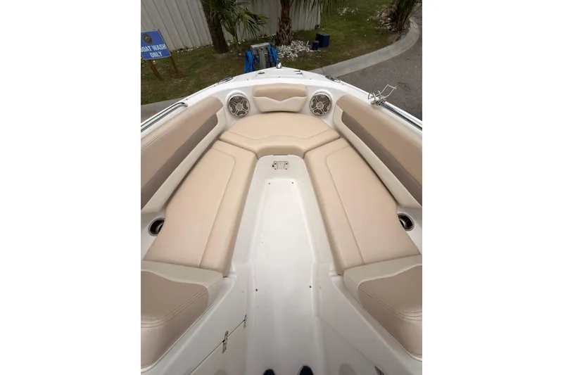 Slide: The Image of 2012 Chaparral 216 SSi boat interior with beige seating and speakers. - 11