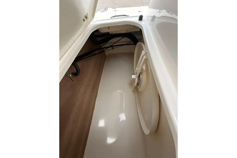 Slide: The Image of Interior storage compartment of 2012 Chaparral 216 SSi boat, featuring clean design and wiring. - 21