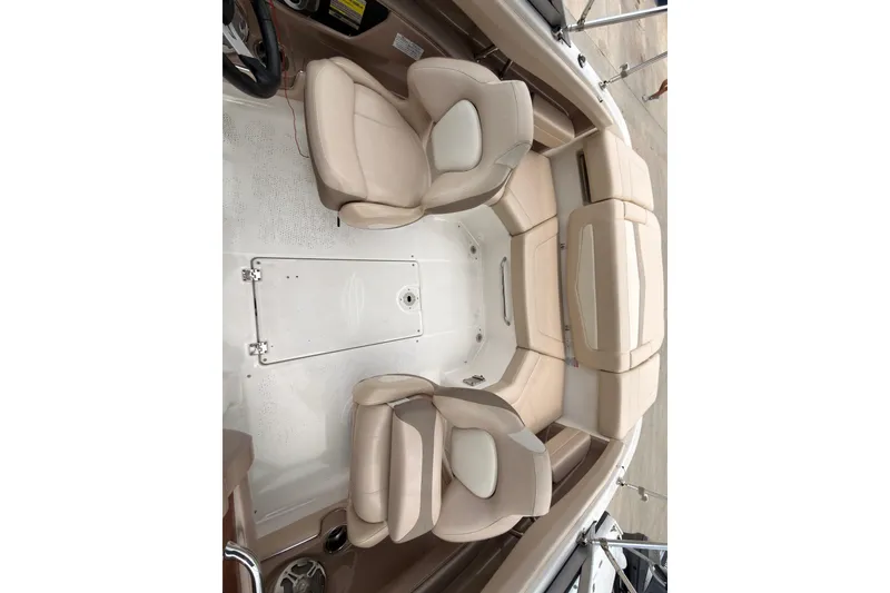 Slide: The Image of Interior view of a 2012 Chaparral 216 SSi boat with beige seating. - 19