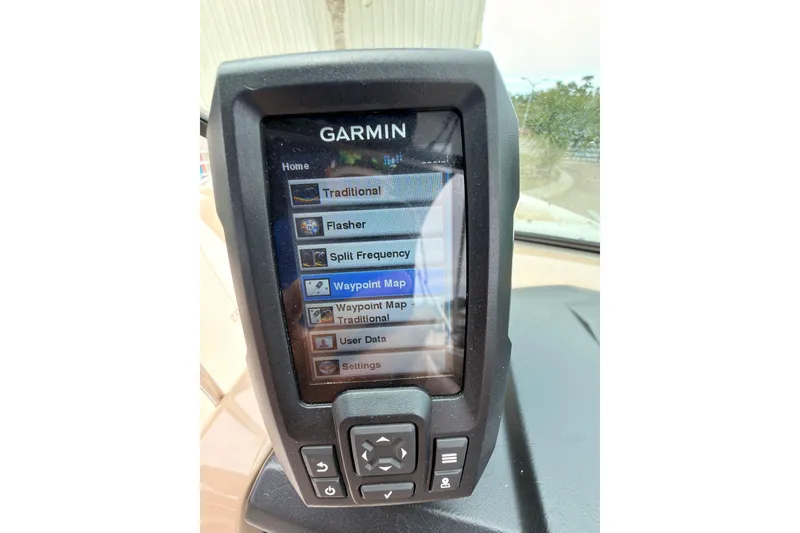 Slide: The Image of Garmin navigation system on 2012 Chaparral 216 SSi boat dashboard displaying menu options. - 28