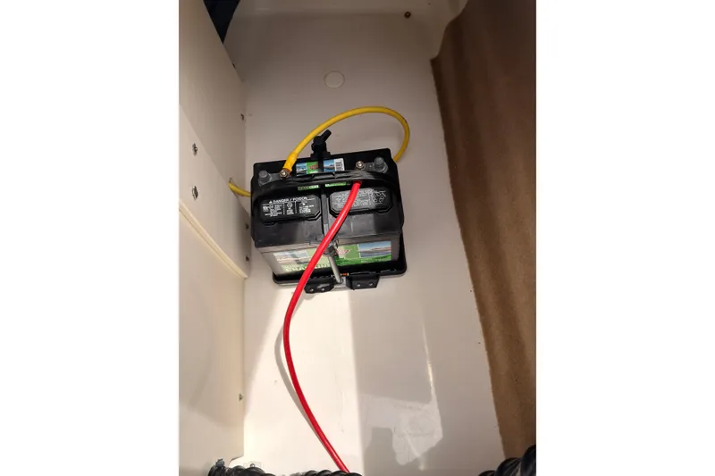 Slide: The Image of Battery compartment of a 2012 Chaparral 216 SSi boat with connected cables. - 43