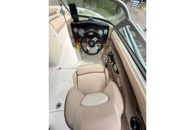 Slide: The Image of Interior view of 2012 Chaparral 216 SSi boat cockpit with steering wheel and controls. - 15