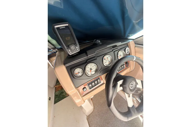 Slide: The Image of 2012 Chaparral 216 SSi dashboard with Garmin GPS and steering wheel. - 23