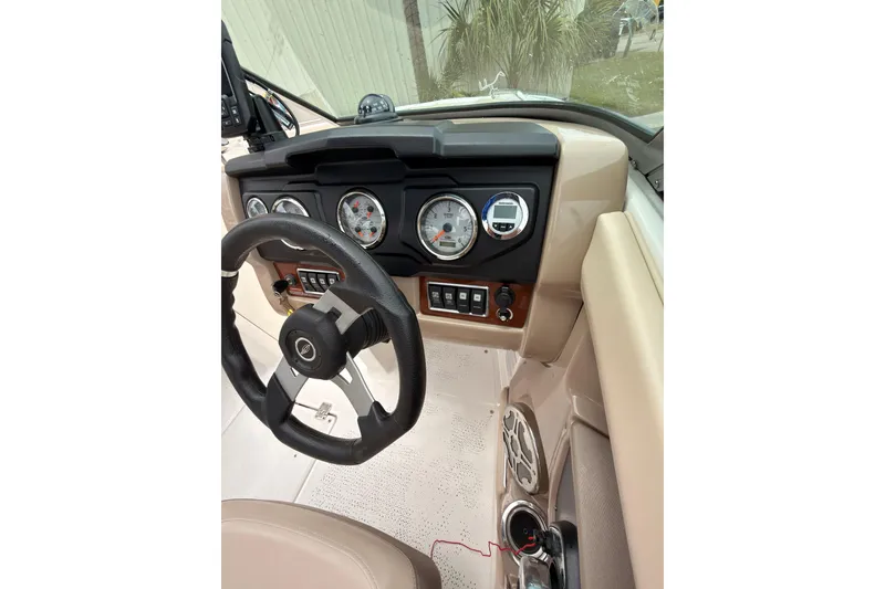 Slide: The Image of 2012 Chaparral 216 SSi boat dashboard with steering wheel and instrument panel. - 17
