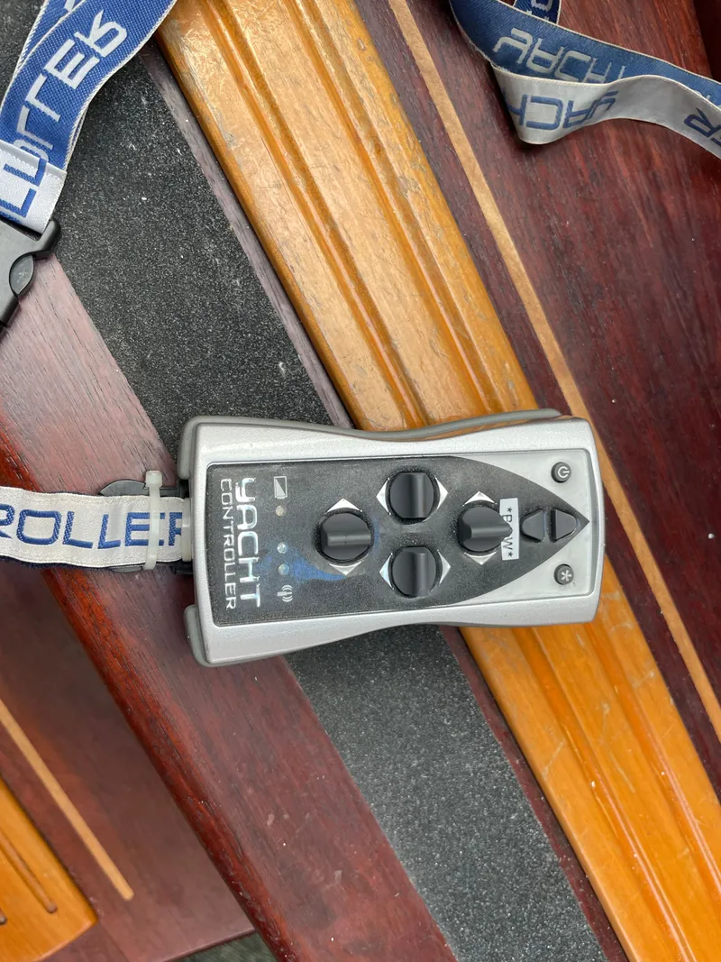 Slide: The Image of A yacht remote control rests on a wooden table. - 10