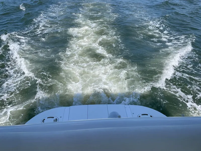 Slide: The Image of A boat leaves a foamy wake in the water. - 13