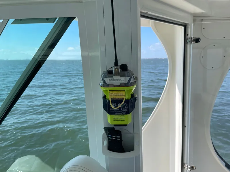 Slide: The Image of A boat on the water with an emergency device mounted on the wall. - 16