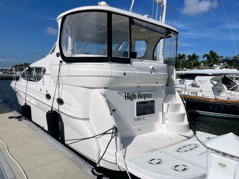 Slide: The Image of A white yacht named "High Hopes" is docked. It features a covered upper deck. - 2