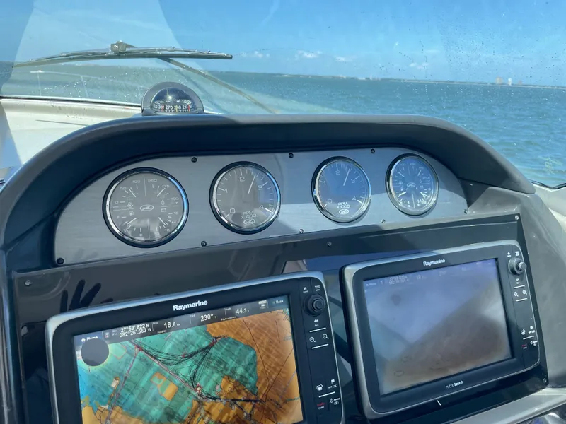 Slide: The Image of The dashboard of a boat with navigation devices and gauges on the water. - 24