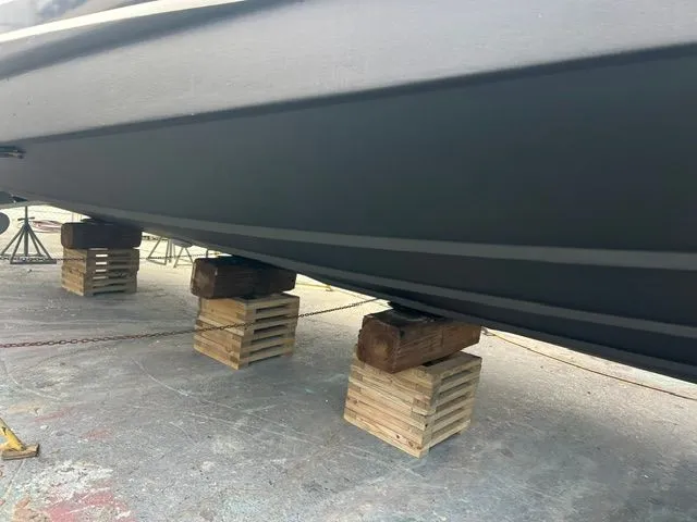 Slide: The Image of A boat on wooden blocks on land, featuring a sturdy hull. - 46