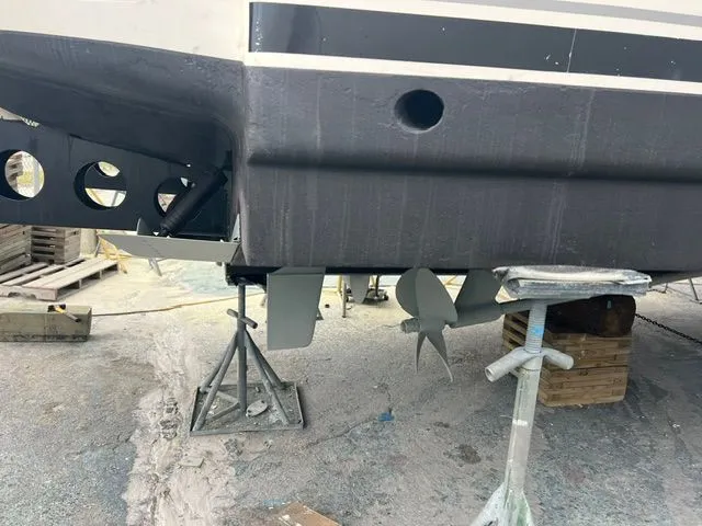 Slide: The Image of A boat on a dry dock with visible propeller and supports. - 49