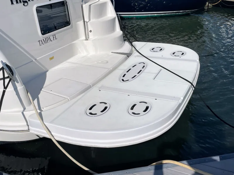 Slide: The Image of The image shows the stern of a white Sea Ray 40MY boat in the water. - 9