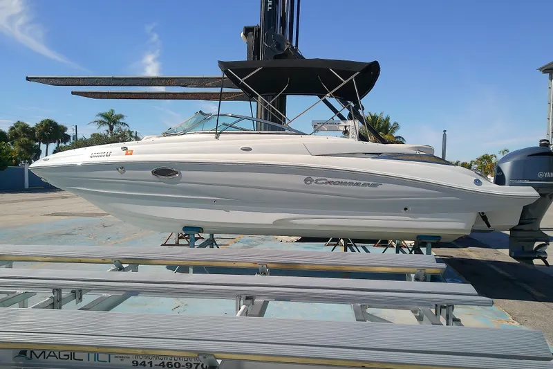 The Image of 2017 Crownline Eclipse E6 XS boat on display, featuring sleek design and canopy. - 0