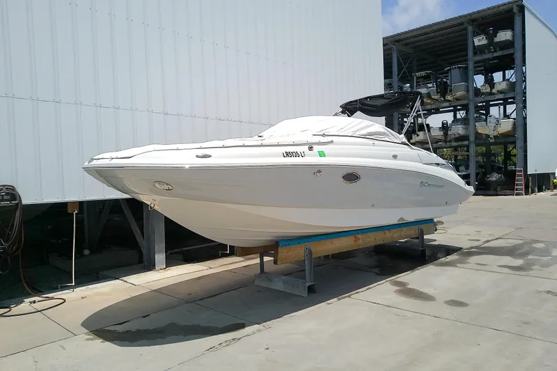 Slide: The Image of 2017 Crownline Eclipse E6 XS boat on dry dock, white exterior, stored outdoors. - 13