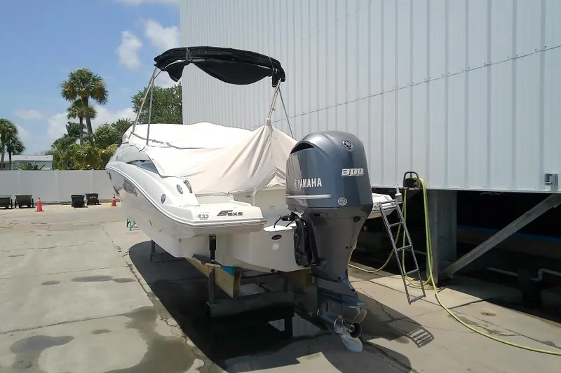 Slide: The Image of 2017 Crownline Eclipse E6 XS boat with Yamaha engine, docked outdoors. - 16