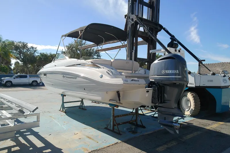 Slide: The Image of 2017 Crownline Eclipse E6 XS boat with Yamaha outboard motor on a lift. - 2