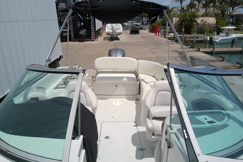 Slide: The Image of 2017 Crownline Eclipse E6 XS boat with spacious seating and sleek design at a marina. - 21