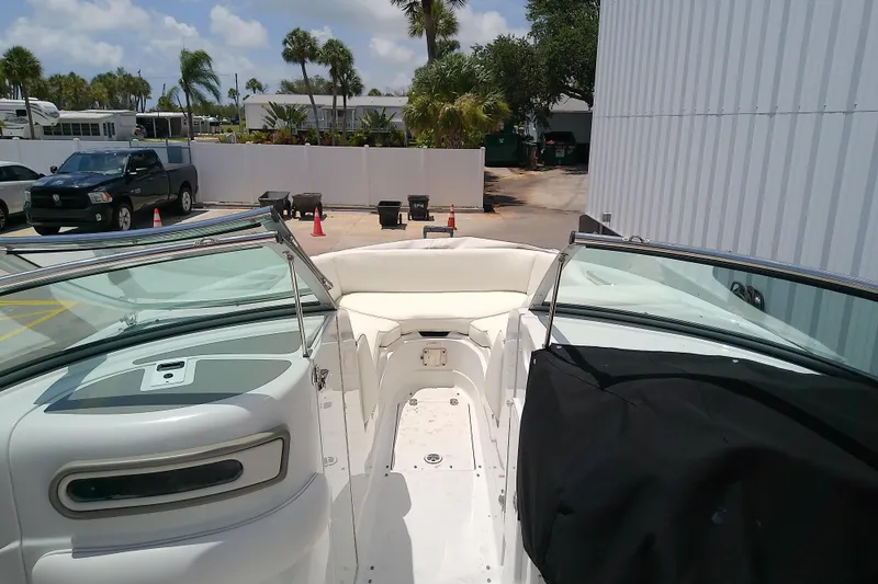 Slide: The Image of 2017 Crownline Eclipse E6 XS boat interior with seating, parked outdoors. - 22