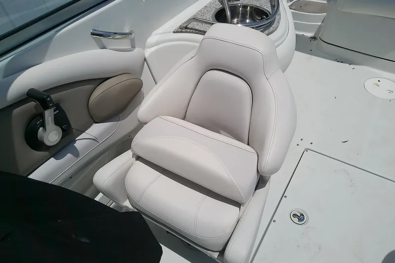 Slide: The Image of 2017 Crownline Eclipse E6 XS boat interior with white captain's chair and control panel. - 26