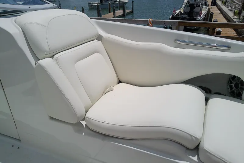 Slide: The Image of Luxurious white seating on 2017 Crownline Eclipse E6 XS boat, dockside view. - 28
