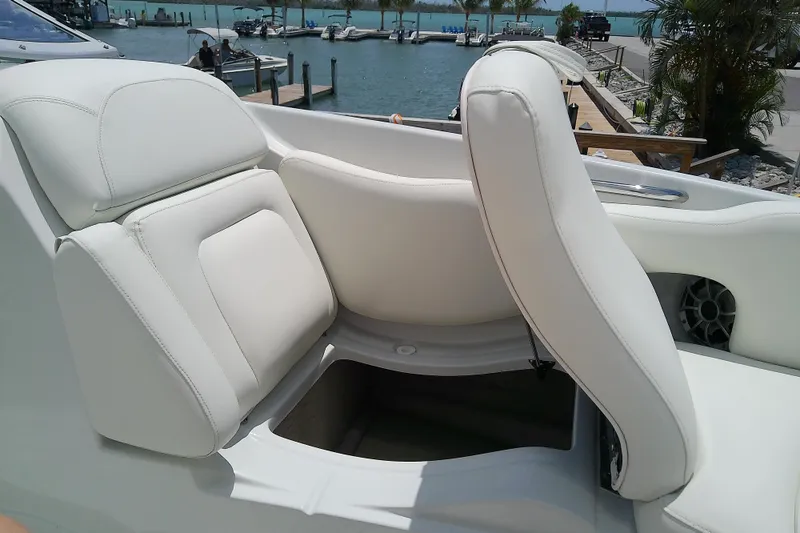 Slide: The Image of 2017 Crownline Eclipse E6 XS boat interior with white seating and storage compartment. - 29