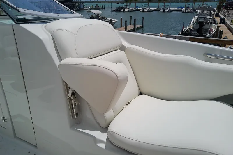 Slide: The Image of 2017 Crownline Eclipse E6 XS boat with white leather seating at a marina. - 30