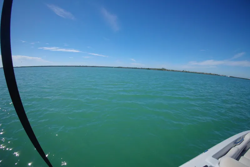 Slide: The Image of 2017 Crownline Eclipse E6 XS on calm blue water under clear sky. - 36