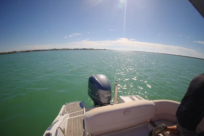 Slide: The Image of 2017 Crownline Eclipse E6 XS boat on sparkling blue water under clear sky. - 37