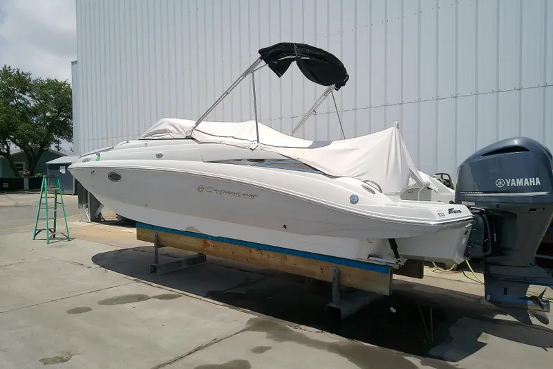 Slide: The Image of 2017 Crownline Eclipse E6 XS boat with Yamaha engine, covered and docked outdoors. - 4