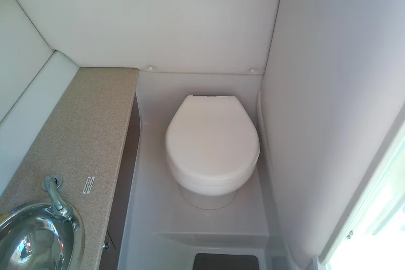 Slide: The Image of 2017 Crownline Eclipse E6 XS boat bathroom with toilet and sink. - 49