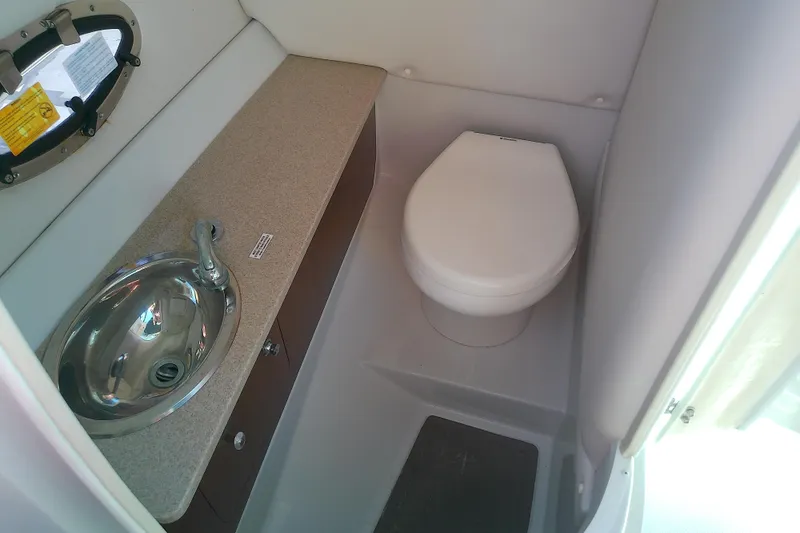 Slide: The Image of 2017 Crownline Eclipse E6 XS boat bathroom with sink and toilet. - 50