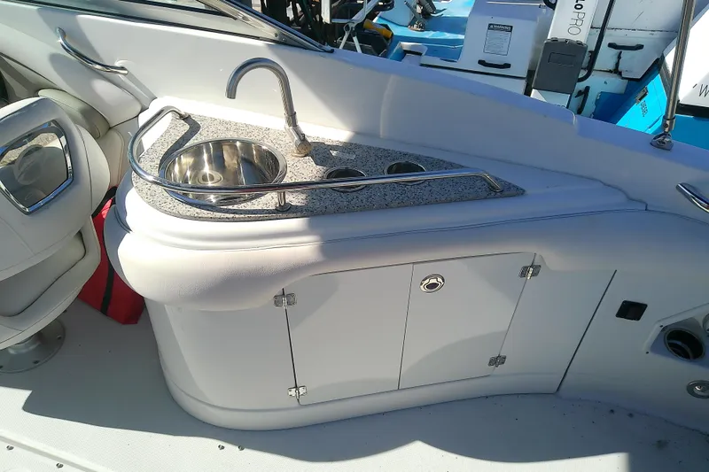 Slide: The Image of 2017 Crownline Eclipse E6 XS boat interior with sink and storage cabinet. - 52