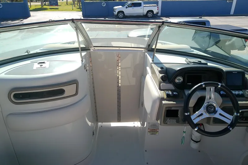 Slide: The Image of 2017 Crownline Eclipse E6 XS boat cockpit with steering wheel and dashboard controls. - 54