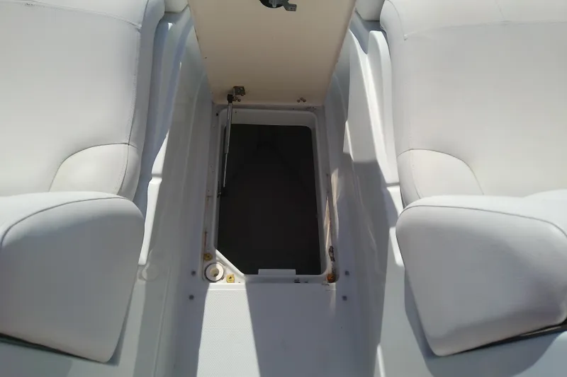 Slide: The Image of 2017 Crownline Eclipse E6 XS boat interior storage compartment with white seating. - 55