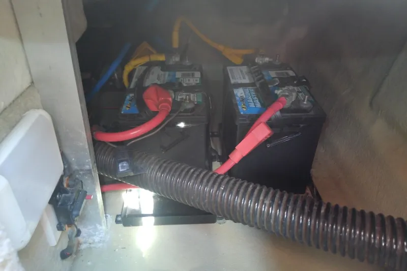 Slide: The Image of Batteries and wiring inside a 2017 Crownline Eclipse E6 XS boat compartment. - 58