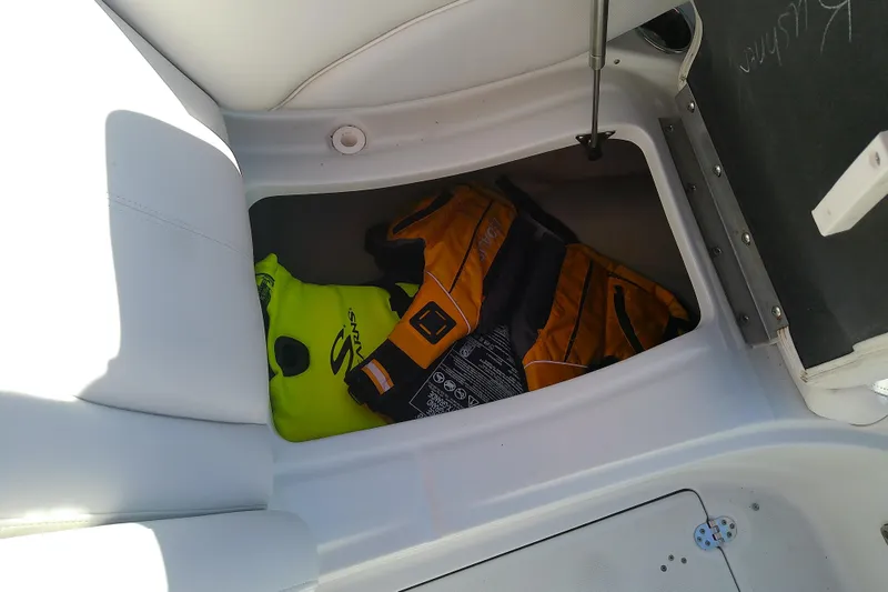 Slide: The Image of Storage compartment in a 2017 Crownline Eclipse E6 XS boat with life jackets. - 61