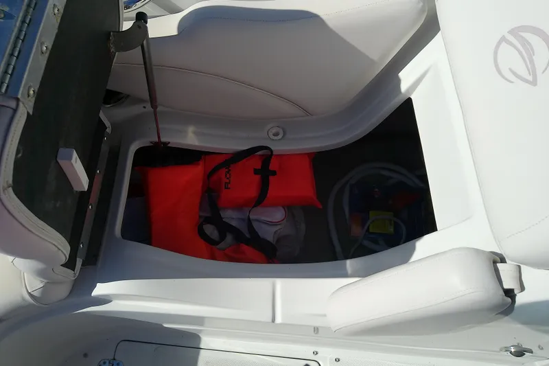 Slide: The Image of Storage compartment in 2017 Crownline Eclipse E6 XS boat with life jacket and supplies. - 62