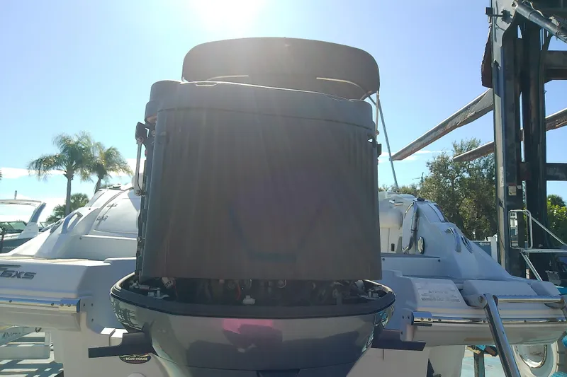 Slide: The Image of 2017 Crownline Eclipse E6 XS boat with outboard motor, sunny day, palm trees in background. - 67