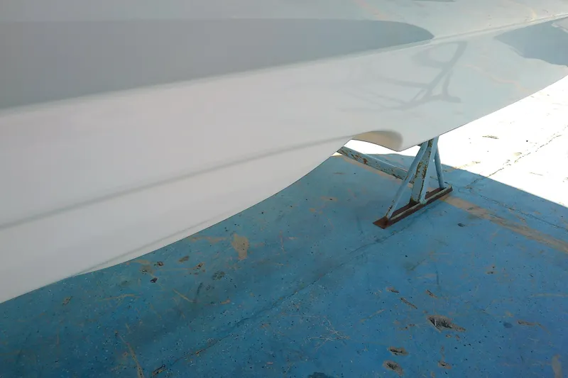 Slide: The Image of 2017 Crownline Eclipse E6 XS boat hull on blue stand, side view. - 7